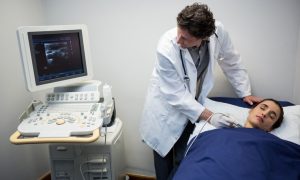 doctors-performing-doppler-sonography-patient-neck_107420-68952